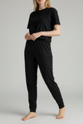 Care Design black cotton-lycra adult pants with high waist and ankle cuffs, designed for comfort with or without diapers.