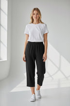 Care Design black 3/4 length capri pants with elastic waist and side zippers.