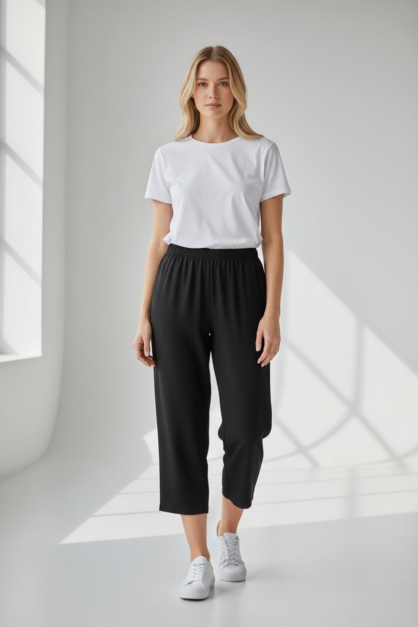 Care Design black 3/4 length capri pants with elastic waist and side zippers.