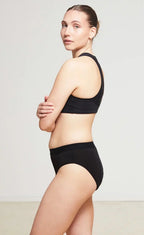 Care Design black low-waist incontinence briefs with built-in barrier, made from a blend of nylon, polyester, viscose, and spandex.