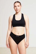 Care Design black low-waist incontinence panties with built-in absorbent barrier, made from OEKO-TEX certified nylon and spandex blend.