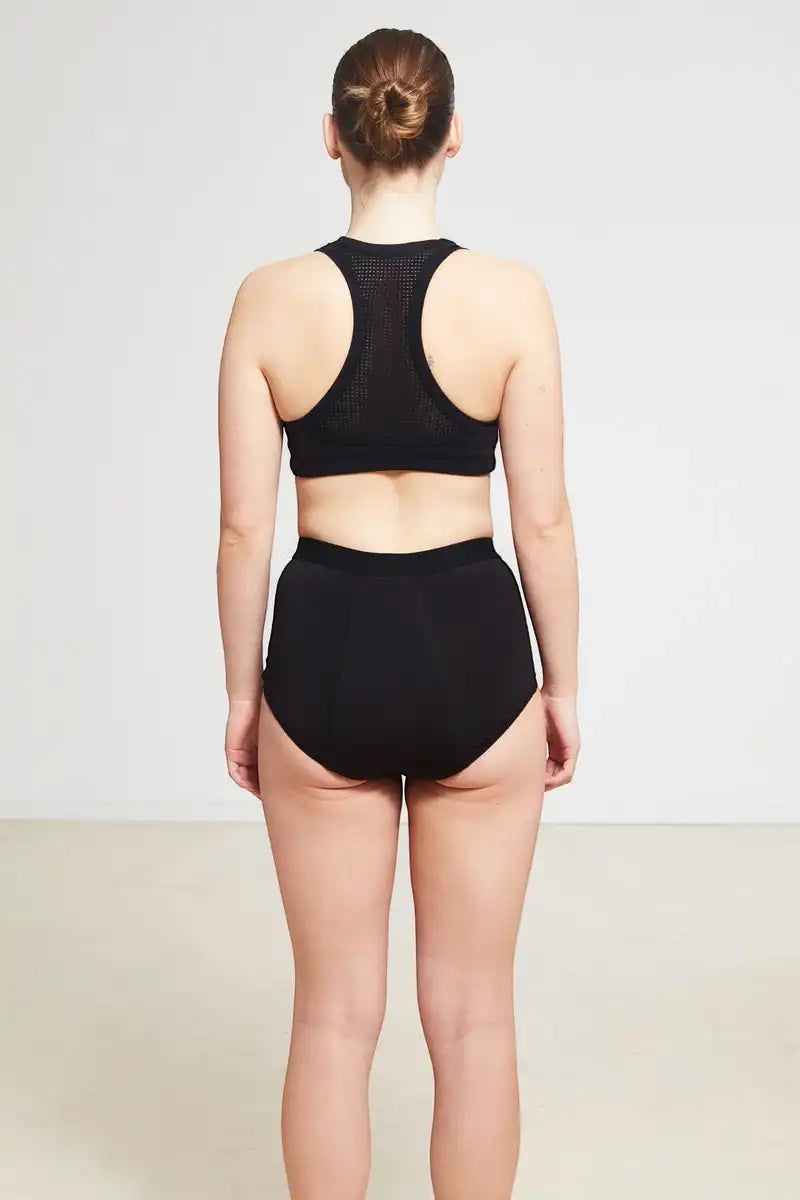 Care Design black high-waisted incontinence panties with built-in barrier, made from nylon, polyester, viscose, and spandex blend.