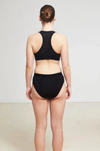 Care Design black low-waist incontinence panties with built-in absorbent barrier for women. OEKO-TEX certified.