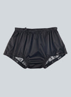 Care Design black polyester incontinence pants for children with built-in leak barrier and elasticated waist and leg openings.