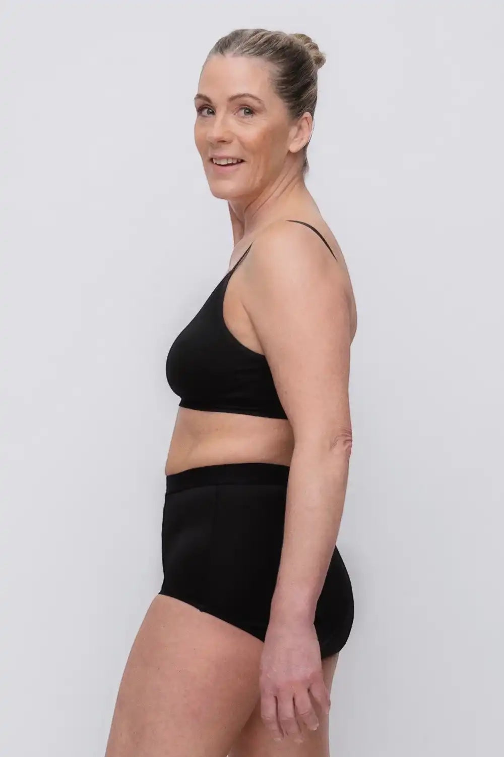 Care Design black high-waisted incontinence underwear with built-in barrier, made from nylon, polyester, viscose, spandex, and rubber.