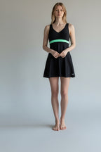 Care Design black "Paris" swimsuit with a mint green band and skirt for women with stoma. V-neck, sleeveless.