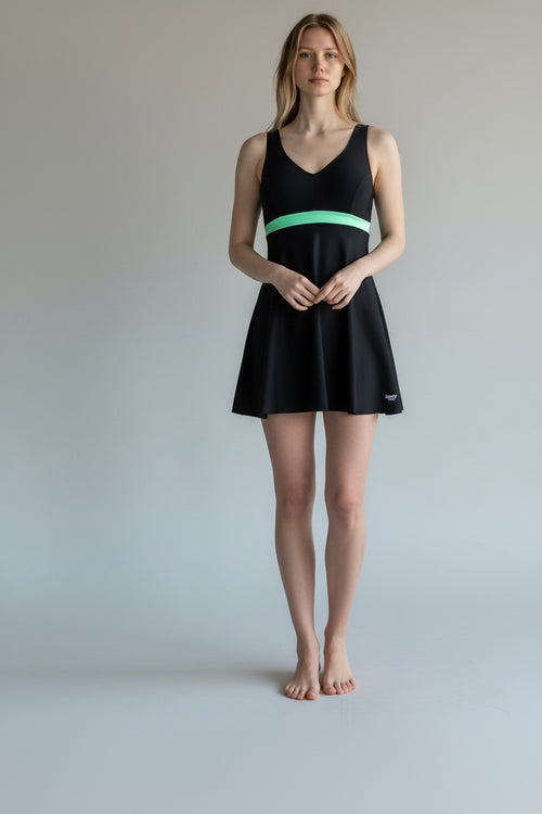 Care Design black "Paris" swimsuit with a mint green band and skirt for women with stoma. V-neck, sleeveless.