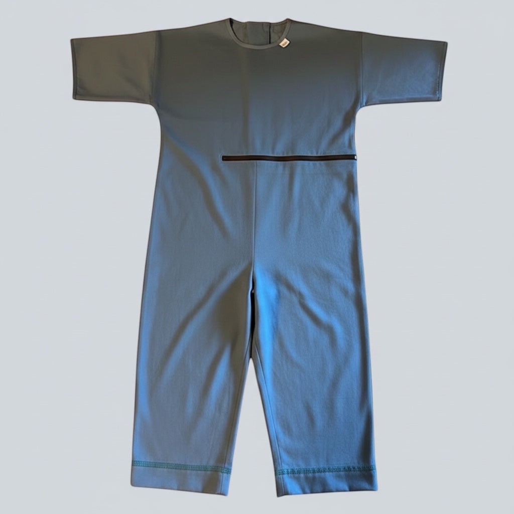Care Design blue short-sleeve bodystocking with front zipper for easy access to feeding tubes and discreet diaper access.