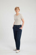 Care Design unisex denim overalls with light grey short-sleeve t-shirt, elastic ankles, and zip front. Cotton-polyester blend.