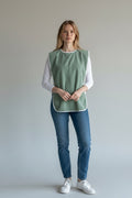 Care Design adult bib in light green terry cloth with white trim. Waterproof and absorbent for mealtime protection.