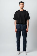 Care Design dark blue denim trousers with full-length leg zips and warm lining. Elastic waist, no pockets.