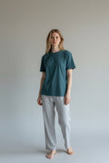 Care Design unisex teal green cotton lycra t-shirt with short sleeves and round neckline. Features binding on sleeves, waist, and neckline.