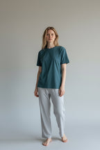 Care Design unisex teal green cotton lycra t-shirt with short sleeves and round neckline. Features binding on sleeves, waist, and neckline.