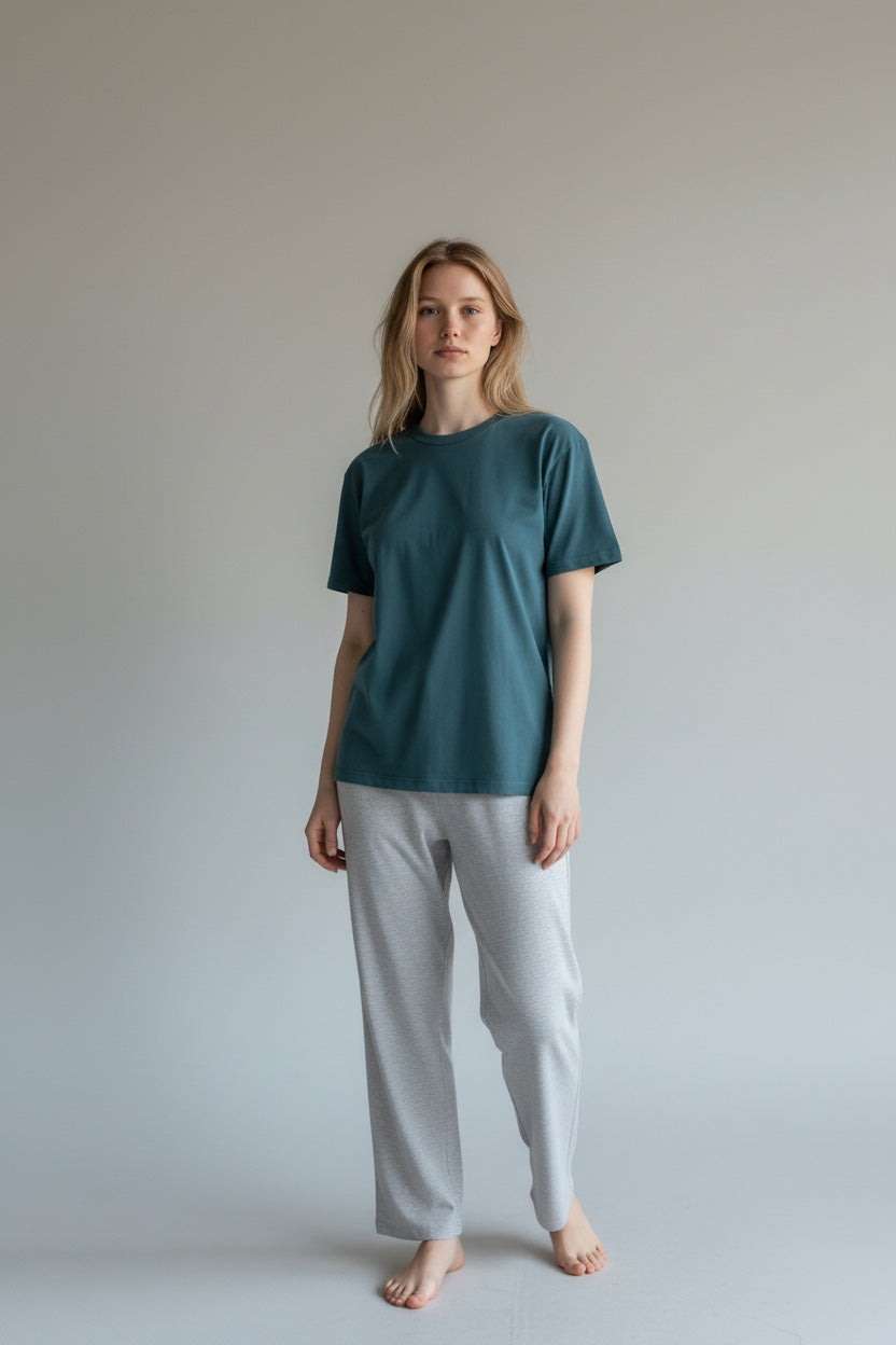 Care Design unisex teal green cotton lycra t-shirt with short sleeves and round neckline. Features binding on sleeves, waist, and neckline.