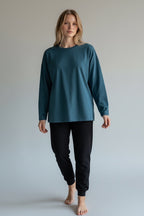 Care Design teal long-sleeve pyjama top with black pyjama bottoms. Comfortable loungewear set.