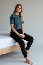 Care Design teal short-sleeve t-shirt and black pyjama bottoms set.