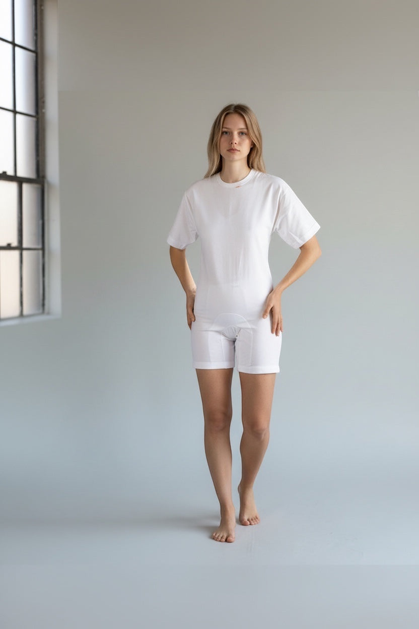 Care Design white cotton short-sleeve, short-leg bodystocking with shoulder zippers and leg band for secure fit.